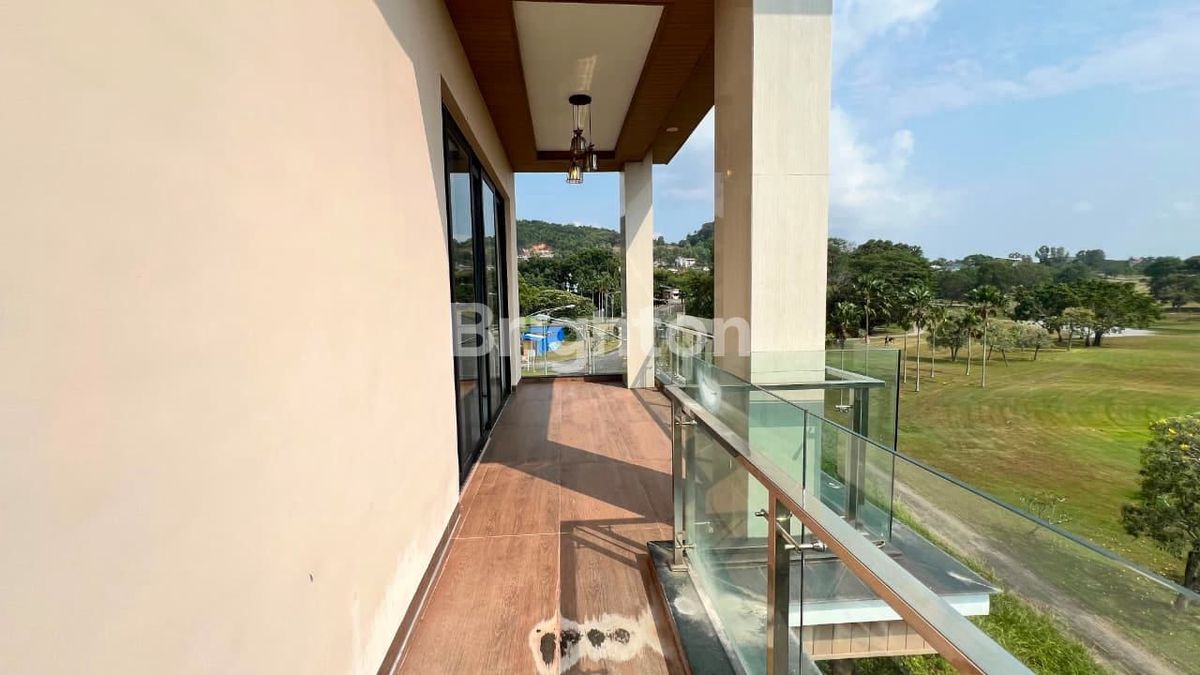 Glass-railed balcony facing greenery at Sukajadi Golf View house Batam