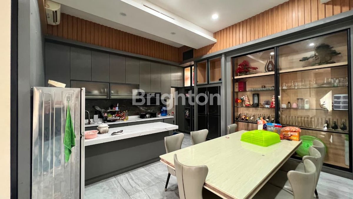 Kitchen and dining area of 3-storey Sukajadi Golf View house Batam